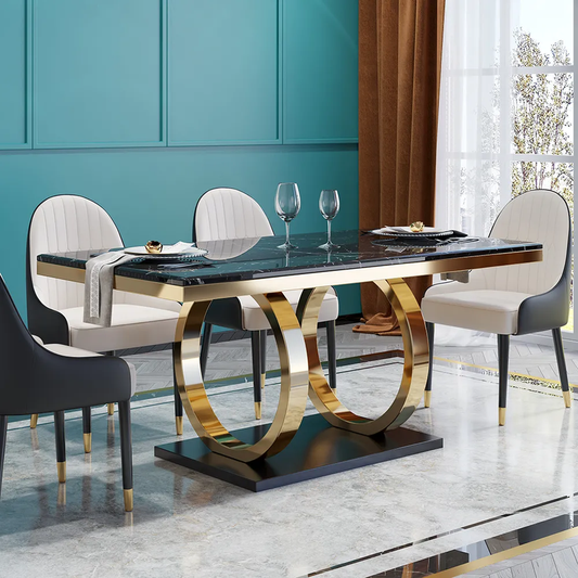 Dining table with gold legs and black marble top in a modern room.