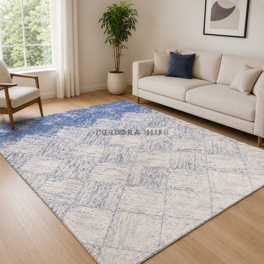 Living room with a blue and white patterned rug, beige sofa, and a plant.