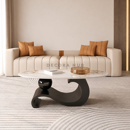 Modern living room with a white sofa, decorative pillows, and a marble coffee table.