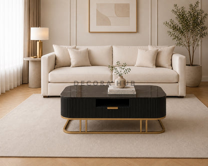 Modern living room with a beige sofa, black coffee table, and decorative elements.
