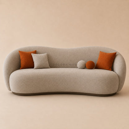 Beige sofa with orange and gray cushions on a beige background