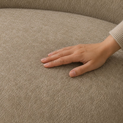 Hand touching a textured beige fabric surface
