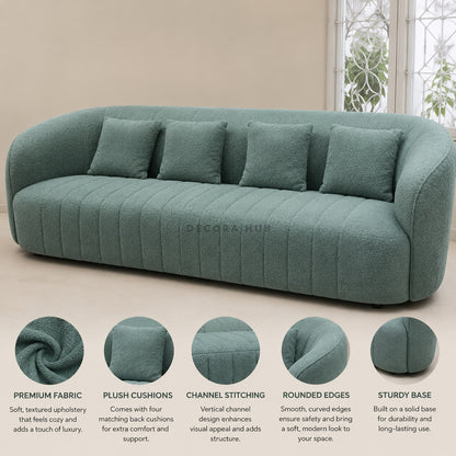 Green sofa with plush cushions on a beige background