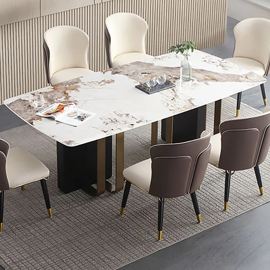 Modern rectangular dining table with a white marble-patterned top and black metal legs, surrounded by six upholstered dining chairs in cream and taupe tones on a gray rug.